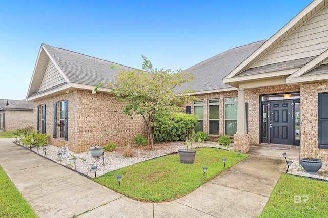 view of side of home with a lawn