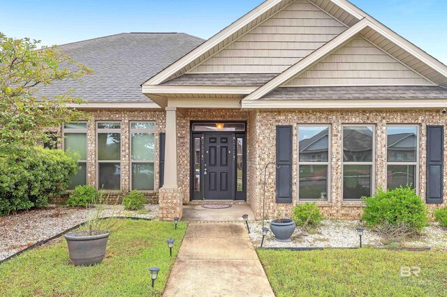 doorway to property with a yard