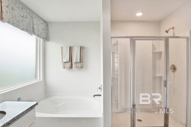 bathroom featuring separate shower and tub, plenty of natural light, and vanity