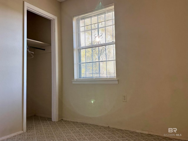 unfurnished bedroom featuring carpet flooring and a closet