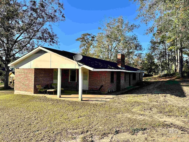 back of house with a lawn