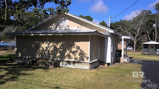 view of side of property with a lawn