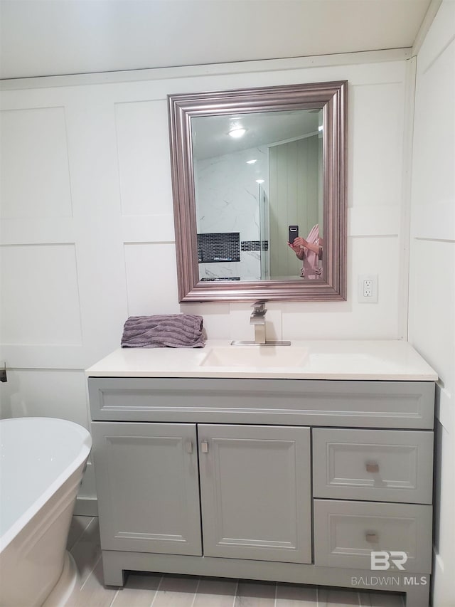 full bathroom with vanity and a freestanding tub