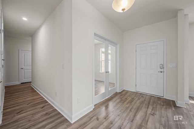 foyer featuring wood finished floors and baseboards