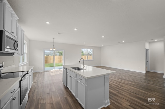 kitchen featuring dark wood finished floors, recessed lighting, appliances with stainless steel finishes, and a sink