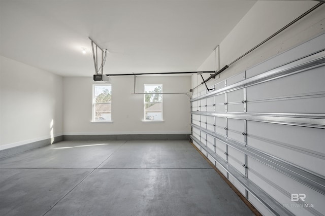 garage with a garage door opener and baseboards