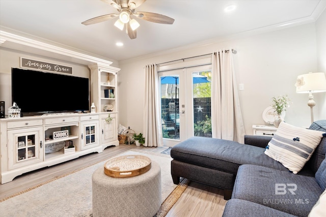 living room with french doors, ornamental molding, ceiling fan, and light hardwood / wood-style flooring