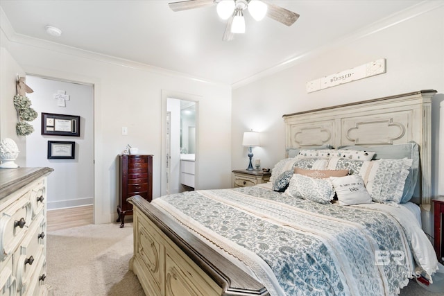 bedroom featuring ceiling fan, light colored carpet, ensuite bathroom, and ornamental molding