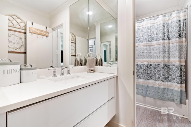 bathroom with hardwood / wood-style floors and vanity