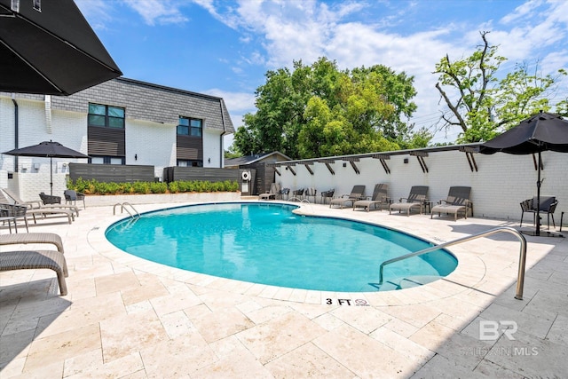 view of swimming pool featuring a patio area