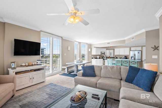 living room featuring light colored carpet, visible vents, and ornamental molding