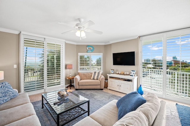 living area featuring ceiling fan, light colored carpet, and ornamental molding