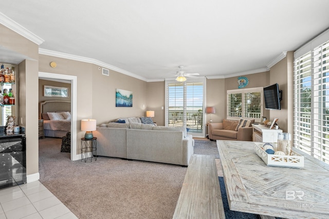 living area with a ceiling fan, beverage cooler, visible vents, light tile patterned flooring, and crown molding