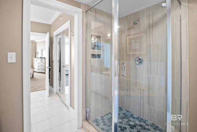 bathroom featuring a stall shower, crown molding, and tile patterned flooring