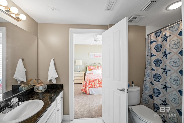 ensuite bathroom featuring connected bathroom, toilet, visible vents, and vanity