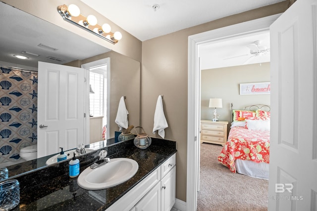 ensuite bathroom featuring vanity, toilet, visible vents, and ensuite bathroom