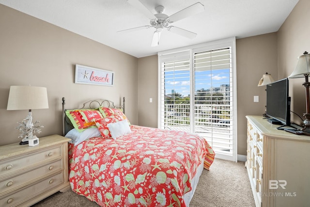 carpeted bedroom featuring baseboards, access to exterior, and a ceiling fan