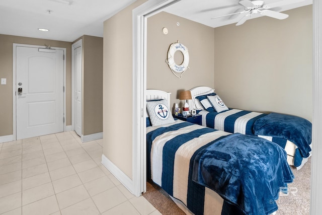 bedroom featuring light tile patterned floors, baseboards, and a ceiling fan