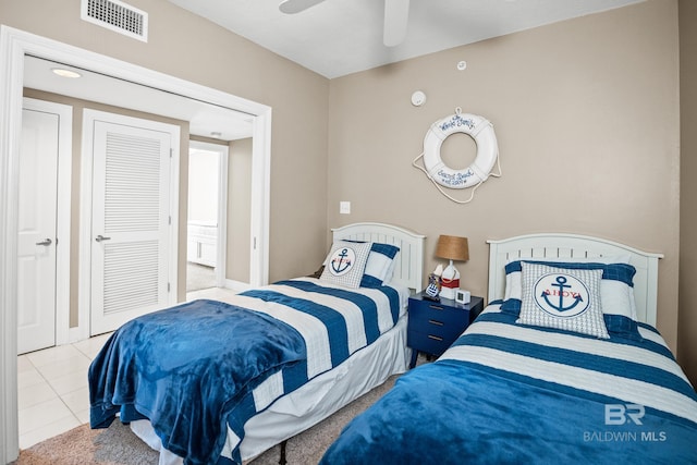 bedroom with tile patterned floors, visible vents, and a ceiling fan