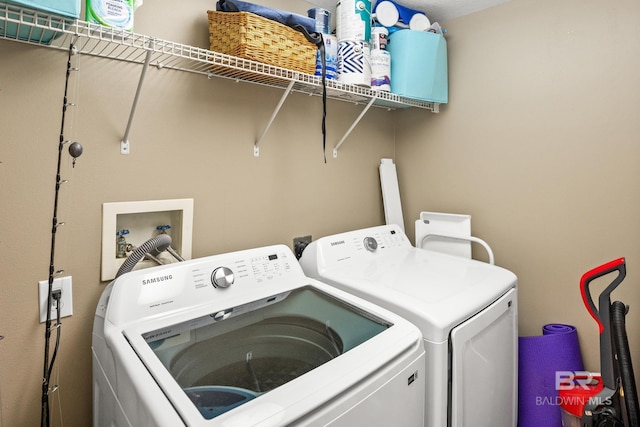 washroom featuring laundry area and washing machine and clothes dryer