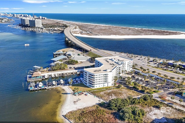 drone / aerial view with a water view and a beach view