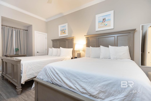 bedroom featuring wood finished floors and ornamental molding