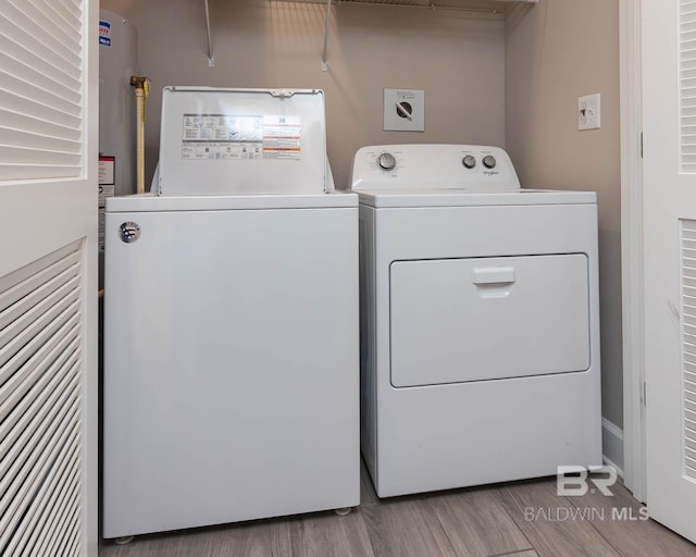 laundry room featuring washing machine and dryer, laundry area, and light wood finished floors