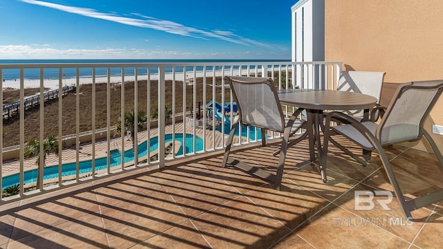 balcony with a beach view and a water view