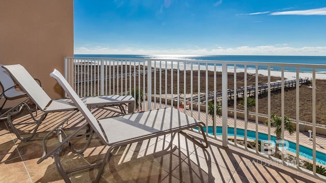 balcony with a view of the beach and a water view