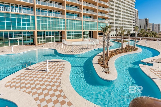 community pool featuring a view of city and a patio area