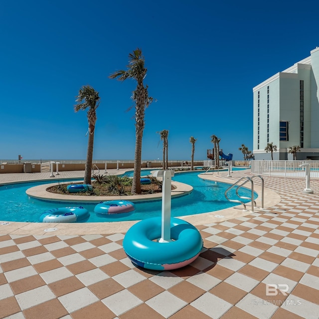 community pool featuring a patio area and fence