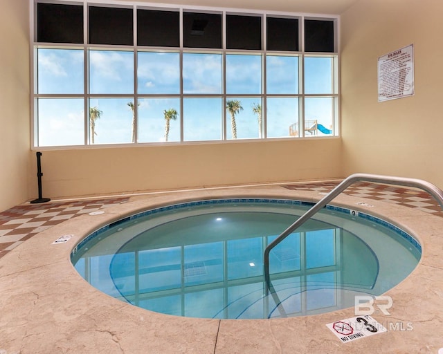 view of swimming pool with an indoor in ground hot tub