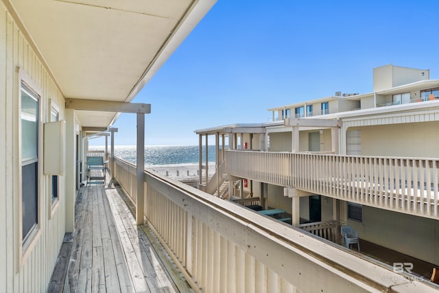 balcony with a water view and a beach view