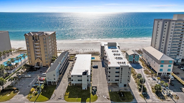 drone / aerial view with a water view and a beach view