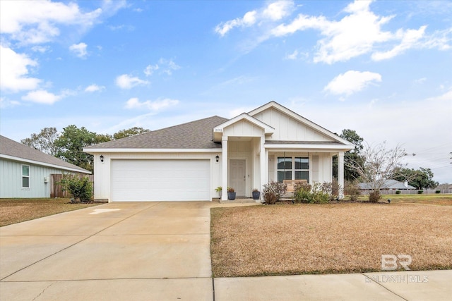 view of front facade featuring covered porch, a front yard, and a garage