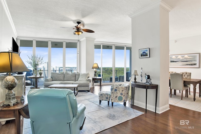 living area featuring floor to ceiling windows, a textured ceiling, and wood finished floors