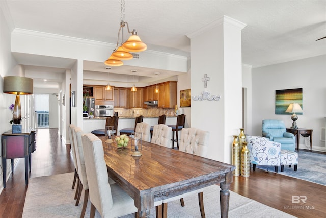 dining area with dark wood-style floors, ornamental molding, visible vents, and baseboards