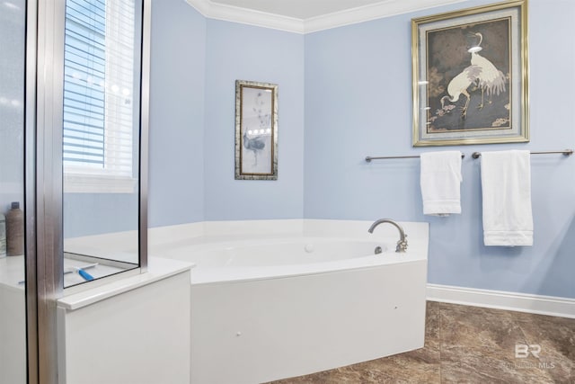 bathroom with ornamental molding, a bath, and baseboards