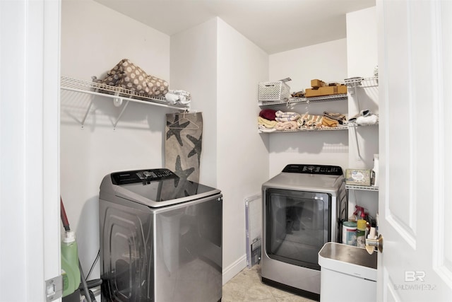 laundry room featuring laundry area, independent washer and dryer, and baseboards