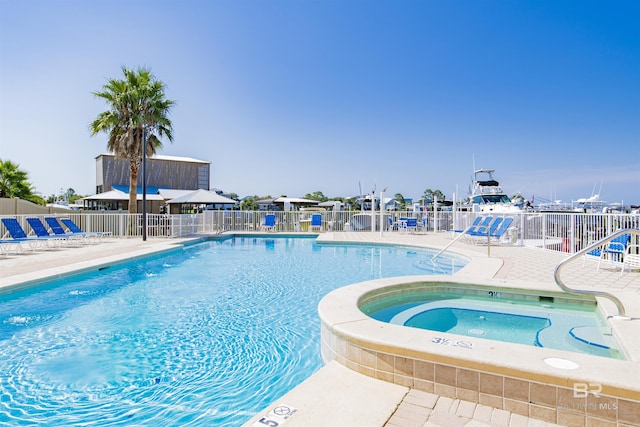 pool featuring a patio area, fence, and a community hot tub