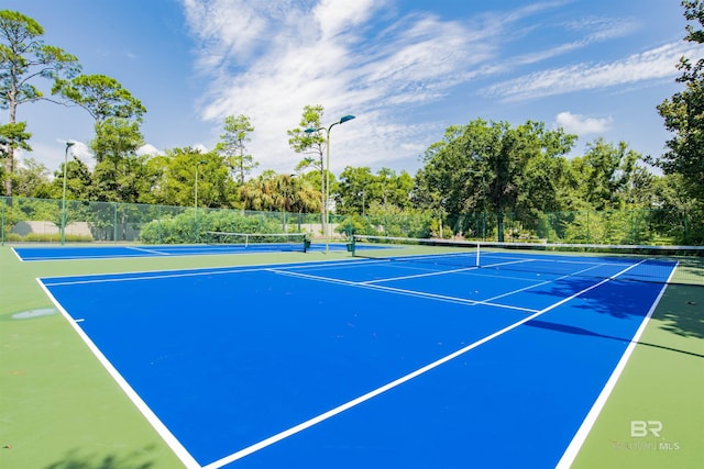 view of sport court featuring fence