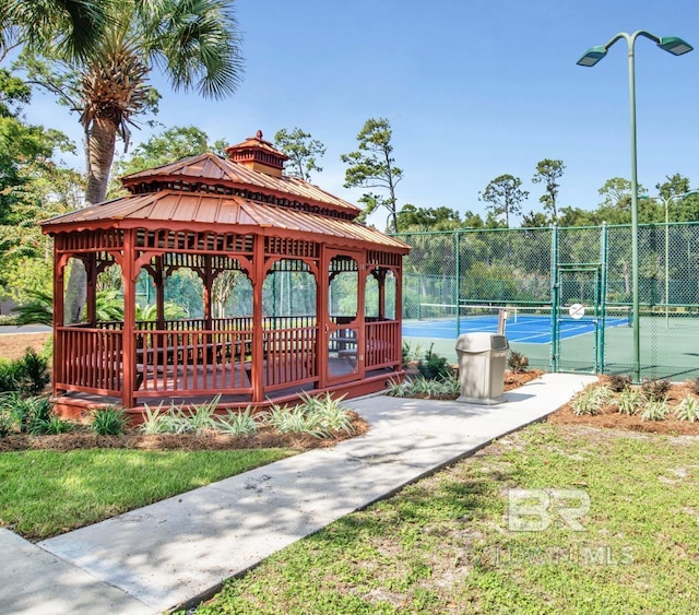 view of home's community featuring a gate, a tennis court, a gazebo, and fence