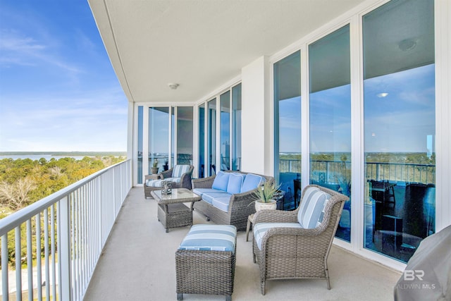 balcony featuring a water view and an outdoor hangout area