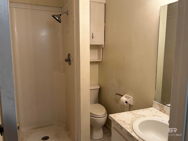 bathroom with walk in shower, vanity, and toilet