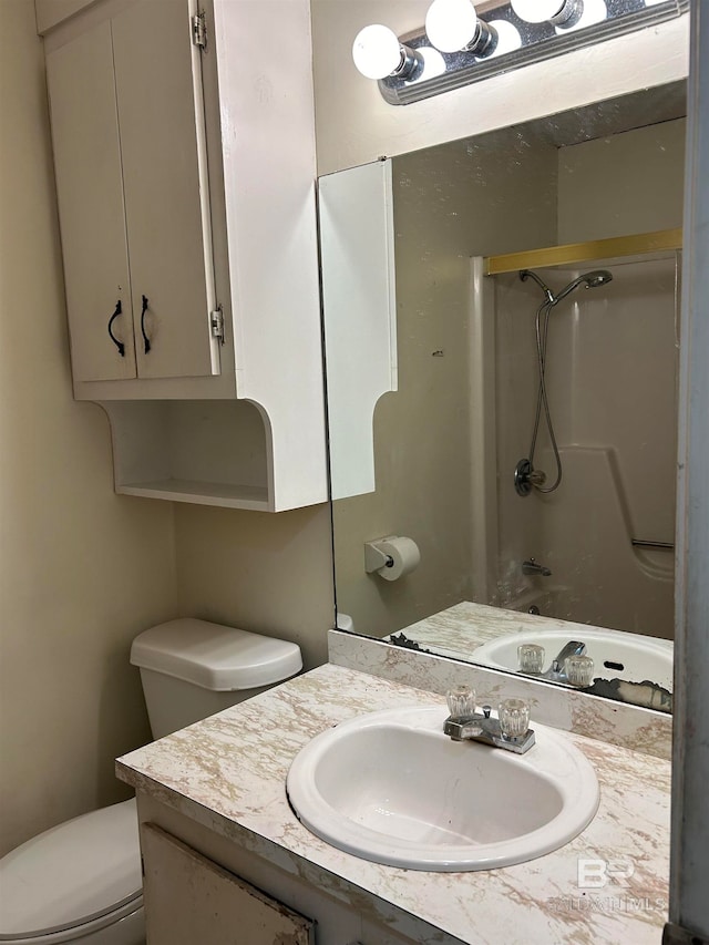 bathroom featuring walk in shower, vanity, and toilet