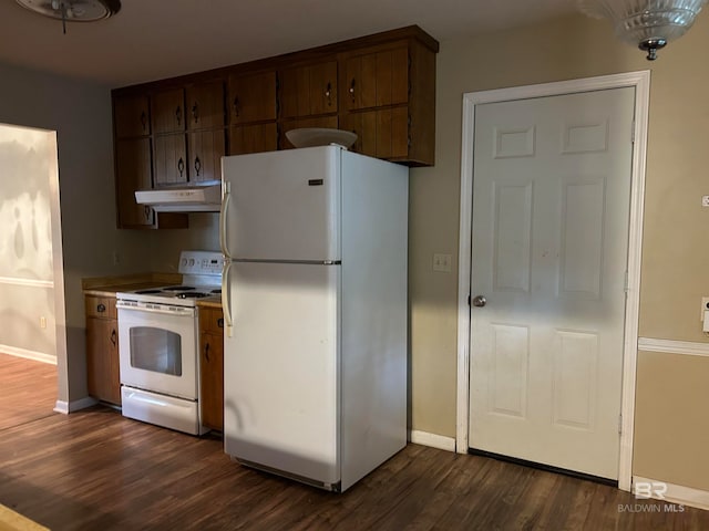 kitchen featuring dark hardwood / wood-style floors and white appliances