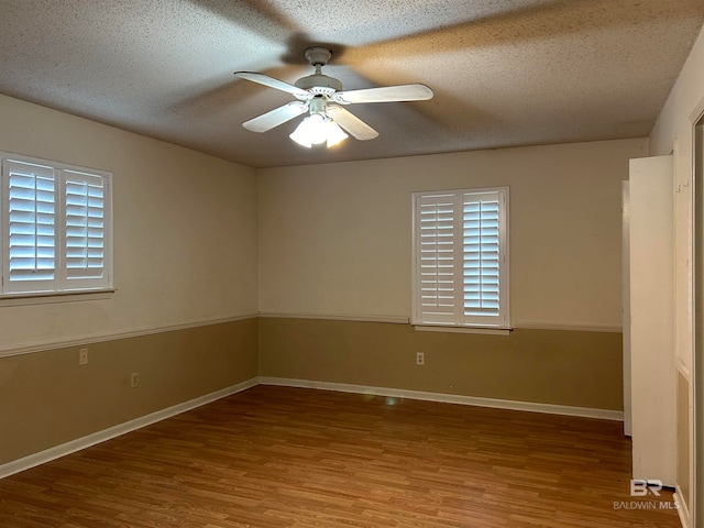 spare room with a textured ceiling, hardwood / wood-style floors, and ceiling fan