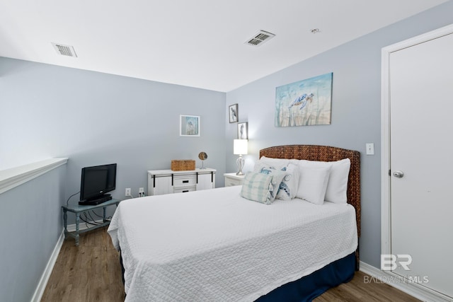 bedroom with dark wood-type flooring