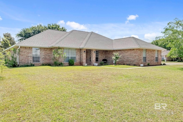 single story home with brick siding, a shingled roof, and a front lawn