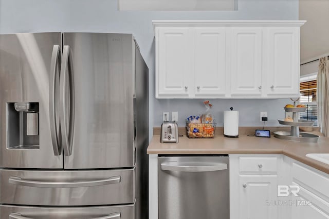 kitchen with white cabinets, appliances with stainless steel finishes, and light countertops